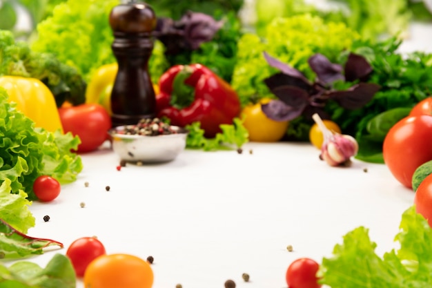 Fresh organic vegetable ingredients for tasty vegetarian cooking around empty space. Healthy or diet food concept