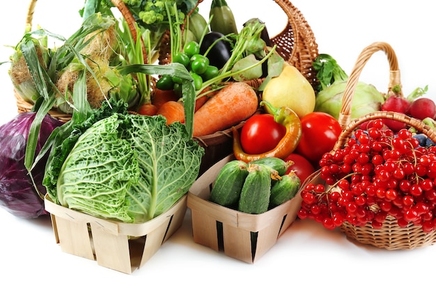 Fresh organic vegetables in wicker baskets, close up