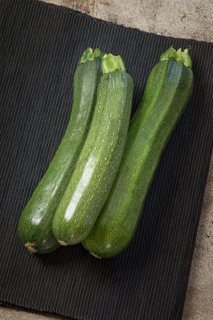 Fresh organic zucchini on the vintage table.