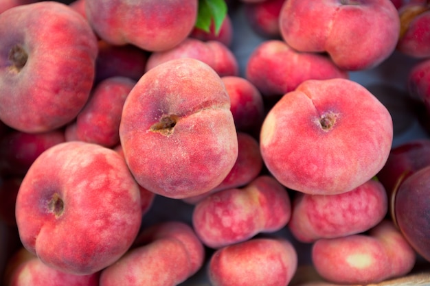 Fresh peaches selling in a market. Horizontal shot with a selective focus