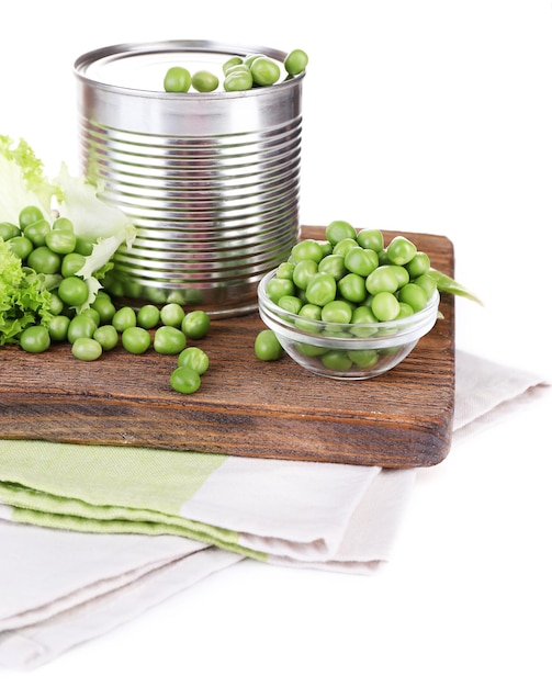 Fresh peas and tin on wooden board isolated on white