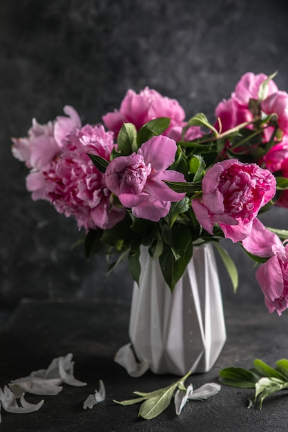 Fresh Peony flowers in vase. bouquet close up. Stylish floral greeting card.