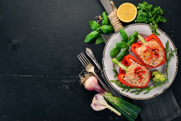 Fresh pepper stuffed with rice and meat On a wooden background Top view Copy space