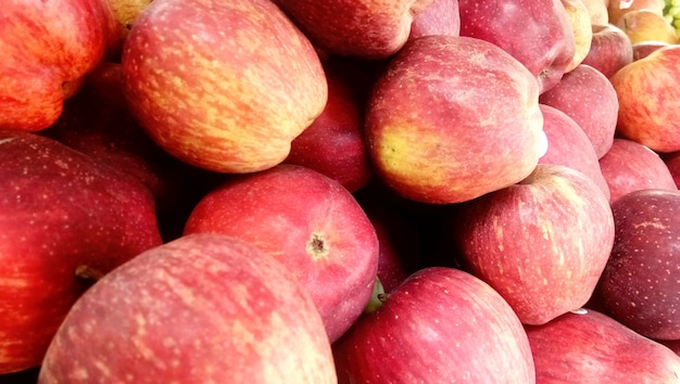 Fresh picked red honey crispy apples background in the harvest season placed in a market or bazaar for sale