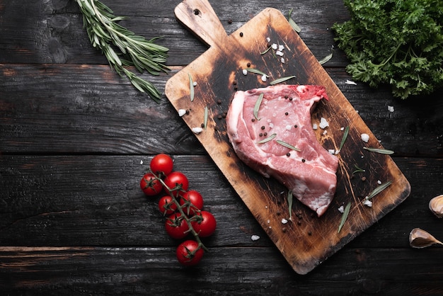 Fresh piece of meat on a cutting board, raw steak on the table.