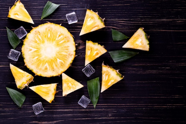 Fresh pineapple on black wood black background