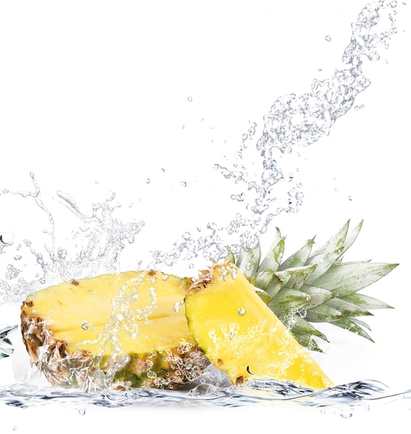 Fresh pineapple falling in water