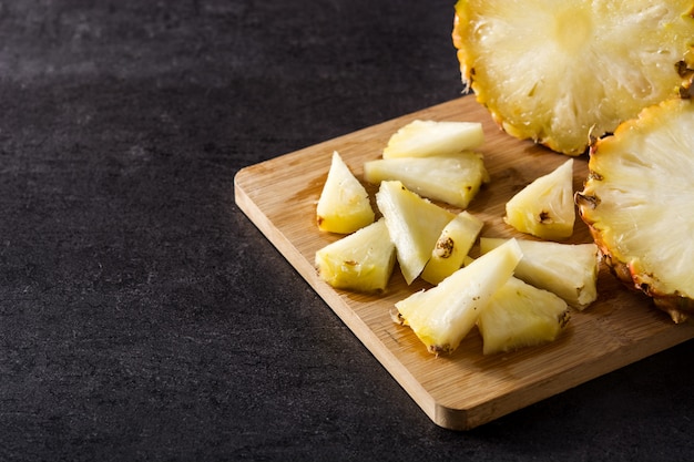 Fresh pineapple slices on cutting board