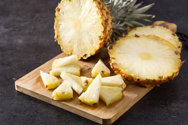 Fresh pineapple slices on cutting board