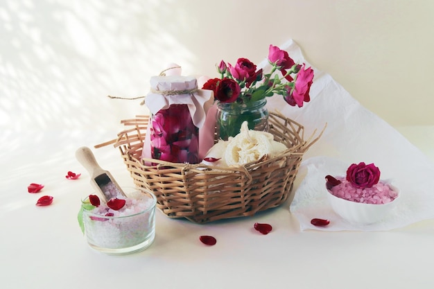 Fresh pink and purple roses water and sea salt with flower petals natural cosmetics