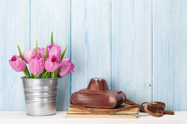 Fresh pink tulip flowers and camera