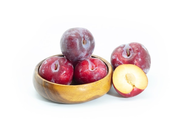 Fresh plum in wooden bowl on background, Healthy food.
Julee plum.