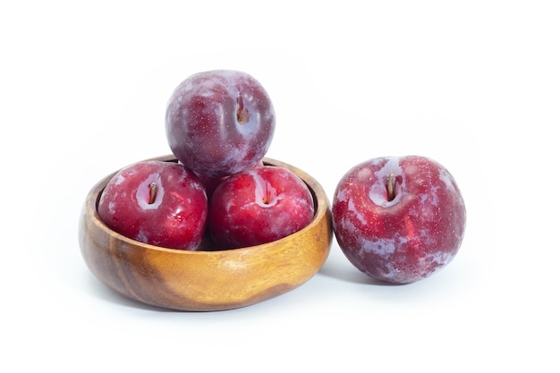 Fresh plum in wooden bowl on background, Healthy food.
Julee plum.