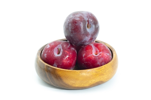 Fresh plum in wooden bowl on background, Healthy food.
Julee plum.