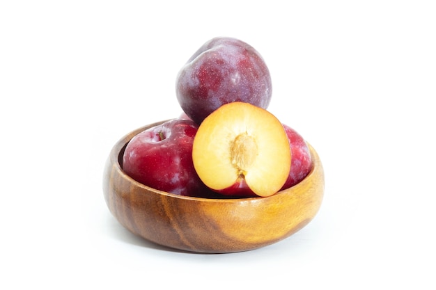 Fresh plum in wooden bowl on background, Healthy food.
Julee plum.