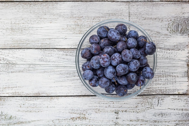 Fresh plums in cup