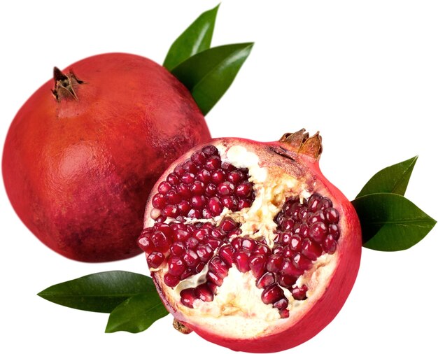 Fresh pomegranates with leaves isolated on white background