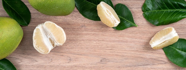 Fresh pomelo fruit on bright wooden table background