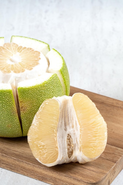 Fresh pomelo fruit on white table background