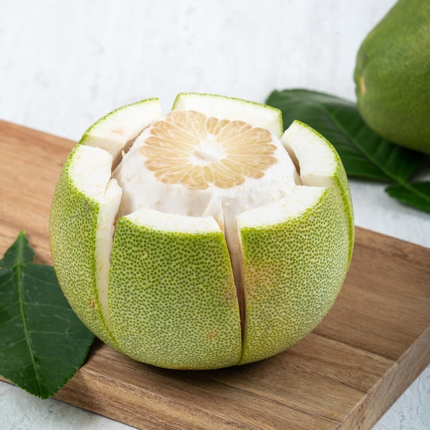 Fresh pomelo fruit on white table background