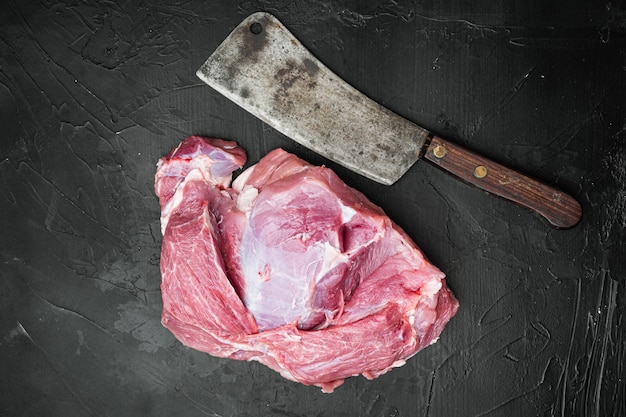 Fresh pork meat  set , with old butcher cleaver knife, on black dark stone table background, top view flat lay