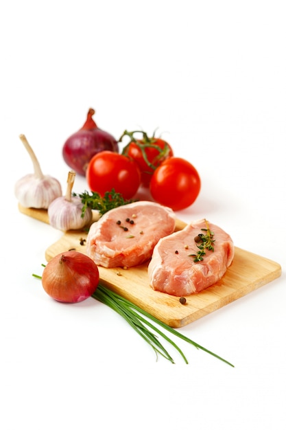 Fresh pork meat steaks with vegetables