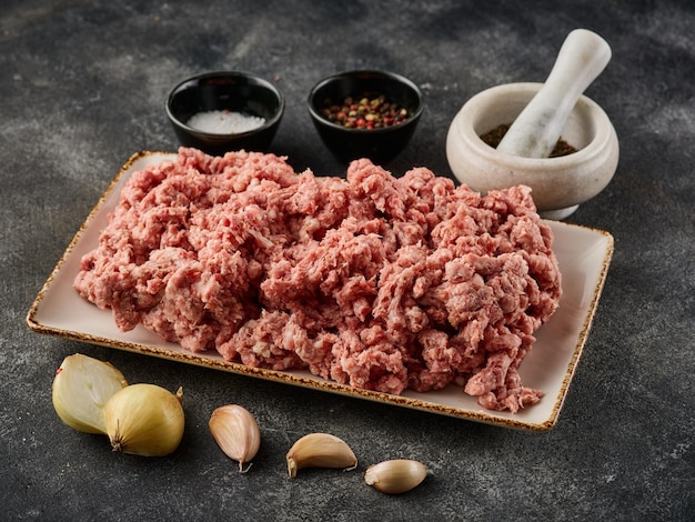 Fresh pork minced meat on grey background Raw minced meat on the plate Raw minced pork