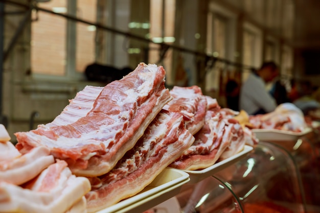 Fresh pork for sell in local market. Seller cut pork to pieces.