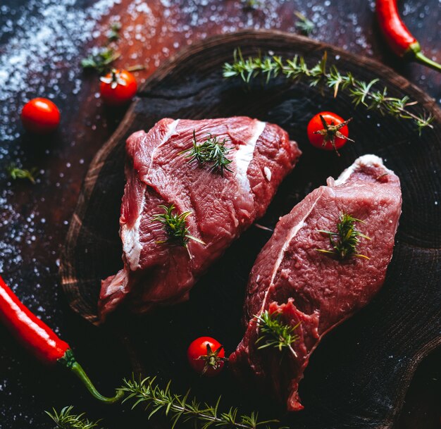 Fresh pork steaks on slate board 