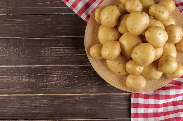 Fresh potatoes on the wood 