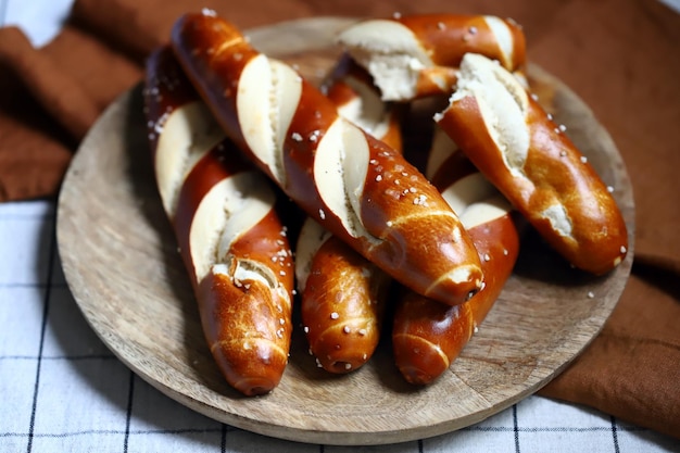 Fresh pretzels on a wooden tray Straight flat pretzels