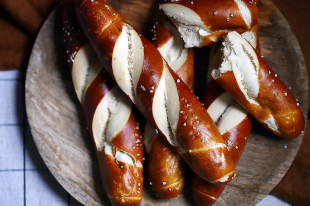 Fresh pretzels on a wooden tray Straight flat pretzels