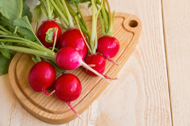 Fresh  of radish on wooden table