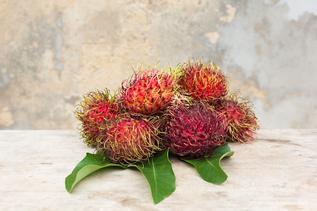 Fresh rambutan on wood background, asian fruit  from Thailand