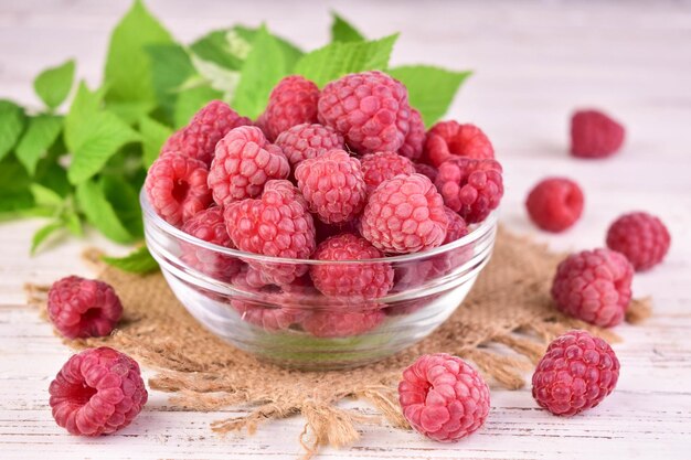 Fresh raspberries in a glass bowl Closeup photo