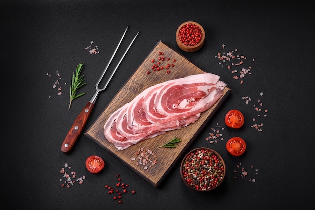 Fresh raw bacon sliced with spices and herbs