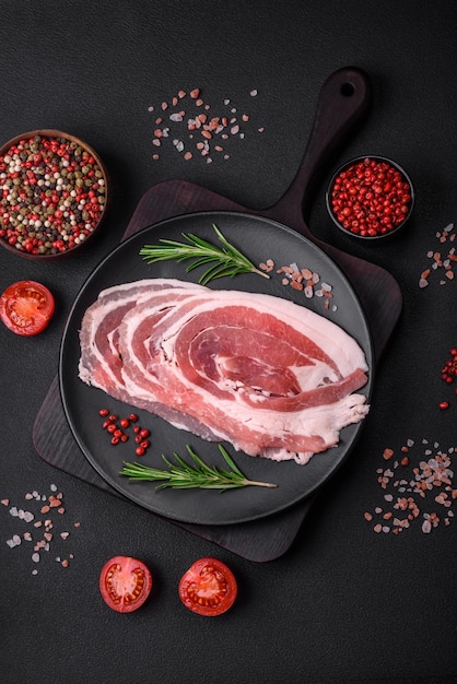 Fresh raw bacon sliced with spices and herbs