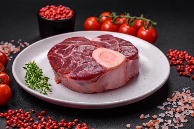 Fresh raw beef steak with bone or ossobuco with salt spices and herbs