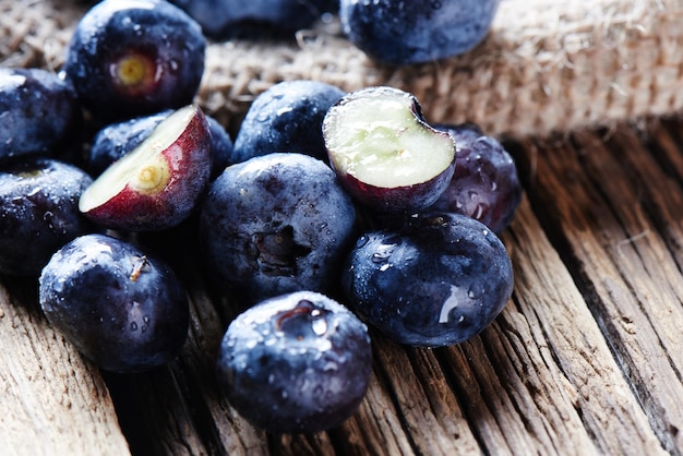 Fresh raw blueberries on wooden background close up