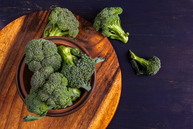 Photo fresh raw broccoli on a wooden table, top view, copy space