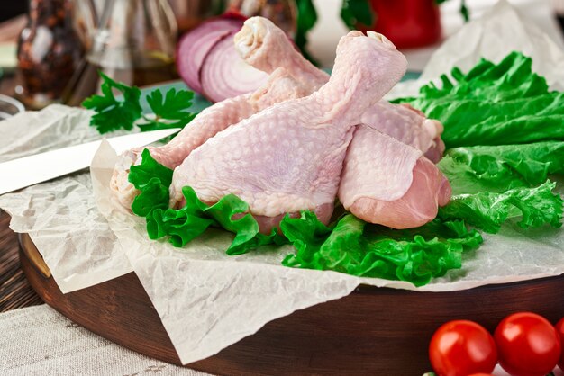 Fresh raw chicken drumsticks on the table