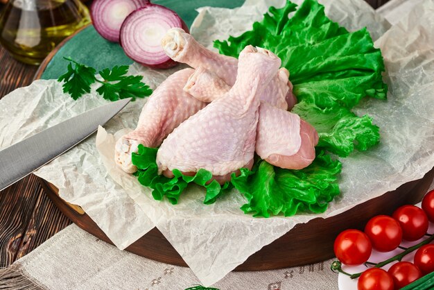 Fresh raw chicken drumsticks on the table