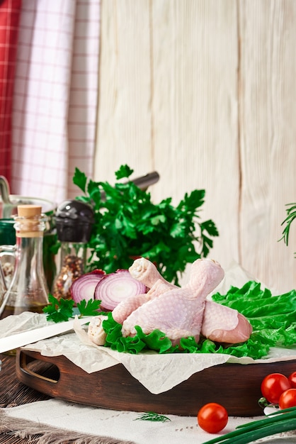 Fresh raw chicken drumsticks on the table