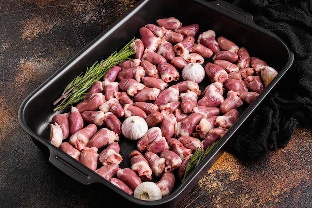 Fresh raw chicken hearts set, on old dark rustic table background