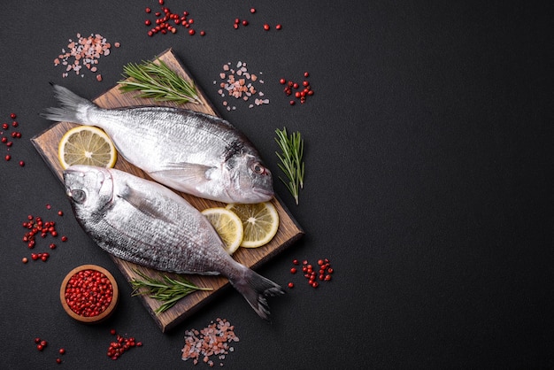 Fresh raw dorado fish with spices herbs salt and lemon