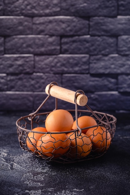 Fresh raw eggs in a metal basket