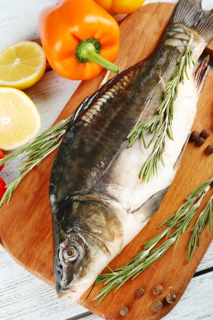 Fresh raw fish and food ingredients on table