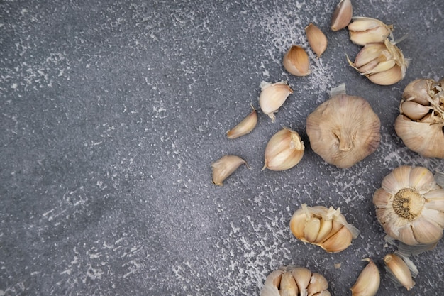 Fresh raw garlic on dark background for cooking concept set up