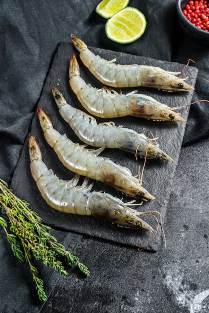 Fresh raw giant langoustine shrimp. Black surface. Top view