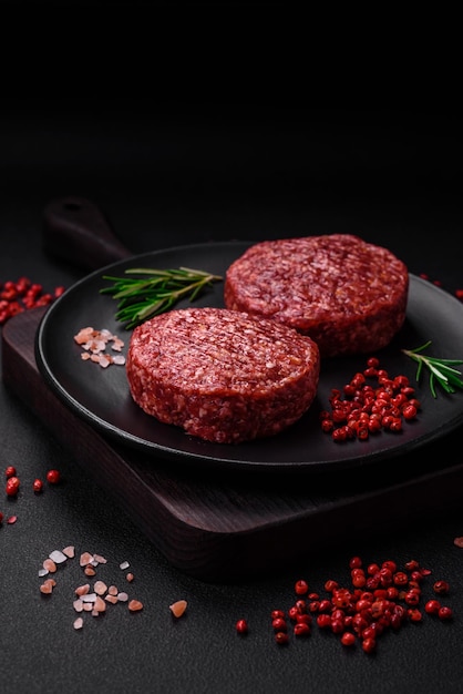 Fresh raw ground beef burger patty with salt and spices